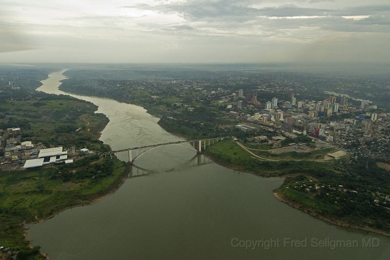 20071204_163219  D2X 4200x2800.jpg - Nice view of Friendship Bridge with La Cuidid del Este, Paraguay on Right and Foz Do, Brazil on left.  We are looking down in the direction of flow of the Parana river.  In a short distance it will merge with the Igaucu River post Iguazu Falls and ultimately empty (form) the del Plate River and empty into the Atlantic